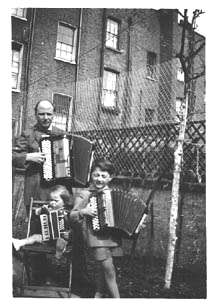 Bruno and children Claudio & Emilio with their accordions in the garden of their home